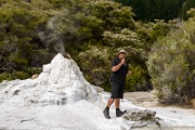 NZ2015-499  Wai-o-Tapu - Lady Knox Geyser. The geyser erupts every day exactly at 10:15 a.m. Just after this man put some chemicals inside. : 2015, New Zealand